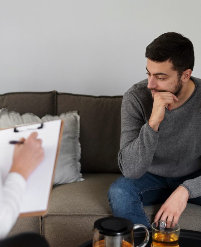 close_up_man_discussing_with_therapist